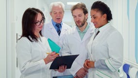 L'équipe médicale regarde le presse-papiers image stock L'équipe médicale regarde le presse-papiers image stock