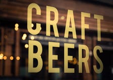 La birra del mestiere firma dentro la finestra della fabbrica di birra fotografia stock La birra del mestiere firma dentro la finestra della fabbrica di birra fotografia stock
