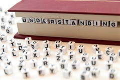 La comprensión de la palabra escrita con las letras entre un libro pagina el fondo blanco con las letras separadas alrededor de c Imagenes de archivo La comprensión de la palabra escrita con las letras entre un libro pagina el fondo blanco con las letras separadas alrededor de c Imagenes de archivo