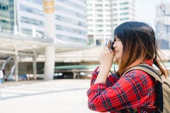 La donna asiatica del viaggiatore bello felice porta lo zaino Le giovani donne asiatiche allegre che usando la macchina fotografi Fotografia Stock La donna asiatica del viaggiatore bello felice porta lo zaino Le giovani donne asiatiche allegre che usando la macchina fotografi Fotografia Stock