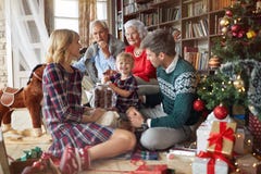 La famiglia allegra celebra una festa di Natale ed il cibo dei biscotti di mas x immagini stock libere da diritti La famiglia allegra celebra una festa di Natale ed il cibo dei biscotti di mas x immagini stock libere da diritti