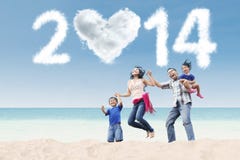 La familia feliz celebra el Año Nuevo 2014 en la playa Imagen de archivo La familia feliz celebra el Año Nuevo 2014 en la playa Imagen de archivo