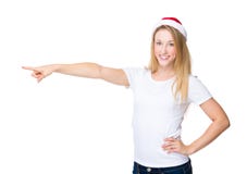 La femme avec le chapeau de Noël et le doigt se dirigent de côté Photo libre de droits La femme avec le chapeau de Noël et le doigt se dirigent de côté Photo libre de droits