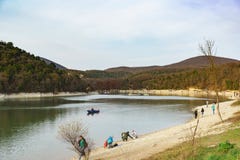 La gente monta los barcos y el paseo alrededor del lago en día caliente del otoño imagen de archivo La gente monta los barcos y el paseo alrededor del lago en día caliente del otoño imagen de archivo