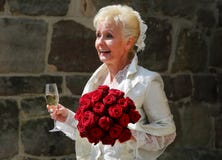 La jeune mariée heureuse souhaite la bienvenue à ses invités de mariage après la cérémonie de mariage devant le vieux château à l photographie stock libre de droits La jeune mariée heureuse souhaite la bienvenue à ses invités de mariage après la cérémonie de mariage devant le vieux château à l photographie stock libre de droits