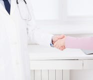 La mano femminile del medico stringe il braccio femminile del suo paziente in clinica, ufficio medico Concetto di sanità, assicur fotografie stock La mano femminile del medico stringe il braccio femminile del suo paziente in clinica, ufficio medico Concetto di sanità, assicur fotografie stock
