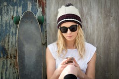 La messagerie textuelle blonde de fille de patineur images libres de droits La messagerie textuelle blonde de fille de patineur images libres de droits