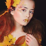 La mujer joven hermosa con otoño compone la presentación en estudio encima foto de archivo libre de regalías La mujer joven hermosa con otoño compone la presentación en estudio encima foto de archivo libre de regalías