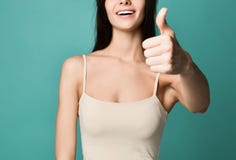 La mujer morena joven hermosa sonriente feliz que muestra los pulgares sube gesto fotografía de archivo libre de regalías La mujer morena joven hermosa sonriente feliz que muestra los pulgares sube gesto fotografía de archivo libre de regalías