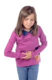 La niña tiene un dolor de estómago foto de archivo La niña tiene un dolor de estómago foto de archivo