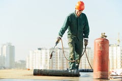 La riparazione piana della copertura per tetti funziona con il feltro del tetto immagine stock La riparazione piana della copertura per tetti funziona con il feltro del tetto immagine stock
