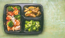 La scatola di pranzo equilibrata sana con il pollo collega in salsa di pomodori con i broccoli verdi e le patate al forno Fotografie Stock Libere da Diritti La scatola di pranzo equilibrata sana con il pollo collega in salsa di pomodori con i broccoli verdi e le patate al forno Fotografie Stock Libere da Diritti