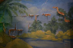 La sera ha dipinto il paesaggio con le palme, la terra ed il cielo sulla vecchia parete Immagine Stock Libera da Diritti La sera ha dipinto il paesaggio con le palme, la terra ed il cielo sulla vecchia parete Immagine Stock Libera da Diritti