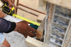 A labor man using a plumb bob for check stock photography A labor man using a plumb bob for check stock photography
