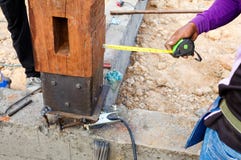 Labor man using a plumb bob for check pillar royalty free stock images Labor man using a plumb bob for check pillar royalty free stock images