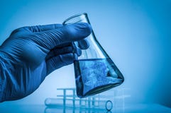 Laboratory beaker in analyst`s hand in plastic glove. royalty free stock photos Laboratory beaker in analyst`s hand in plastic glove. royalty free stock photos