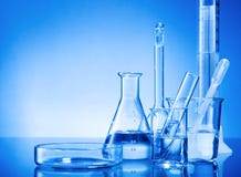 Laboratory equipment, glass flasks, pipettes on blue background Stock Photo Laboratory equipment, glass flasks, pipettes on blue background Stock Photo