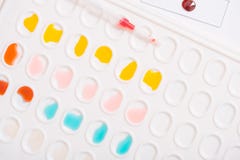 Laboratory pipette with drop of liquid over glass test tubes for a scientific experiment in a science research lab Royalty Free Stock Photo Laboratory pipette with drop of liquid over glass test tubes for a scientific experiment in a science research lab Royalty Free Stock Photo