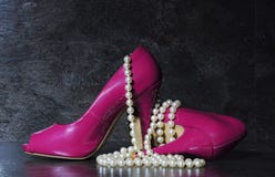 Ladies pink high heels with long strand of white pearls royalty free stock photo Ladies pink high heels with long strand of white pearls royalty free stock photo