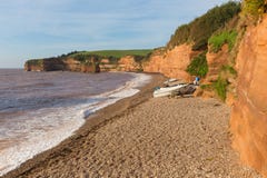 Ladram Bay shingle beach Devon England UK with boats red sandstone rock Jurassic coast Royalty Free Stock Images Ladram Bay shingle beach Devon England UK with boats red sandstone rock Jurassic coast Royalty Free Stock Images