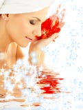 Lady with red petals and snowflakes in water