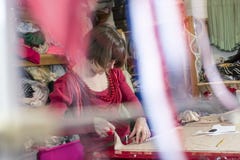 Lady Tailor Working on Cloth on a Cutting Table stock images Lady Tailor Working on Cloth on a Cutting Table stock images