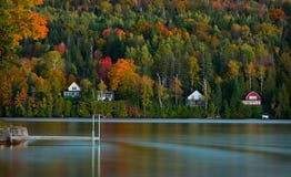 Lake houses line a Vermont pond in peak autumn stock photo Lake houses line a Vermont pond in peak autumn stock photo