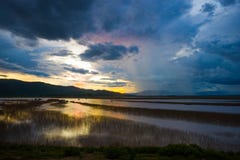 Lake view floating house boat of fishing village at sunset with cloud, rain and storm. Stock Photo Lake view floating house boat of fishing village at sunset with cloud, rain and storm. Stock Photo