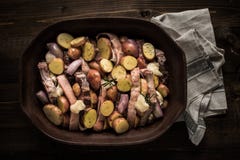 Lamb Loin Chops with Vegetables in Rustic Clay Dish Prepared for Roasting royalty free stock photo Lamb Loin Chops with Vegetables in Rustic Clay Dish Prepared for Roasting royalty free stock photo