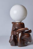 Brown natural wood lamp with white canopy close-up, on light background royalty free stock image Brown natural wood lamp with white canopy close-up, on light background royalty free stock image