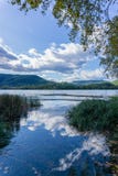 Landscape of Banyoles lake and the reflection in the water of the clouds