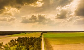 Landscape in the North German Heath near Celle, with a small piece of forest, meadows, fields and a TV tower on the horizon, drama royalty free stock photos Landscape in the North German Heath near Celle, with a small piece of forest, meadows, fields and a TV tower on the horizon, drama royalty free stock photos