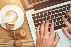 Laptop and coffee cup in male hands on a wooden floor royalty free stock photos Laptop and coffee cup in male hands on a wooden floor royalty free stock photos