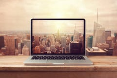 Laptop computer over New York city skyline. Retro filter effect Stock Images Laptop computer over New York city skyline. Retro filter effect Stock Images