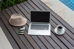 Laptop and hat at the pool. royalty free stock photos Laptop and hat at the pool. royalty free stock photos