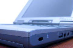 Laptop detail. Laptop - angle shot. Blue colors enhanced digitally. Focus on its margin, shallow depth of field has been used (low aperture Laptop detail. Laptop - angle shot. Blue colors enhanced digitally. Focus on its margin, shallow depth of field has been used (low aperture