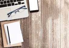 Laptop and smart phone on wooden table background stock images Laptop and smart phone on wooden table background stock images