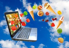 Laptop and various sweets on sky background royalty free stock photography Laptop and various sweets on sky background royalty free stock photography