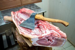 Large ax for chopping meat, meat carcass. Close up. Large piece of meat. Butcher profession stock photography Large ax for chopping meat, meat carcass. Close up. Large piece of meat. Butcher profession stock photography