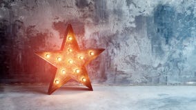 Large decorative retro star with lots of burning lights on grunge concrete background. Beautiful decor, modern design stock photography Large decorative retro star with lots of burning lights on grunge concrete background. Beautiful decor, modern design stock photography