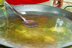 Large flat frying pan or skillet for paella or jambalaya on gas burner. Process of pouring and heating olive oil for cooking meat Royalty Free Stock Photography Large flat frying pan or skillet for paella or jambalaya on gas burner. Process of pouring and heating olive oil for cooking meat Royalty Free Stock Photography