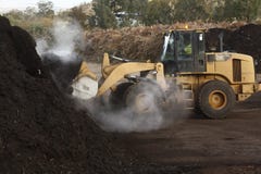 large industrial machinery being used at a garbage dump stock photo large industrial machinery being used at a garbage dump stock photo