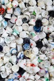 A large number of caps from cans of aerosol paint for graffiti. Smeared with colored paint nozzles lie in a huge pil stock image A large number of caps from cans of aerosol paint for graffiti. Smeared with colored paint nozzles lie in a huge pil stock image