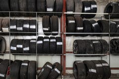 A large number of car wheels with tires stored vertically in racks for storage during a seasonal climate. Auto service royalty free stock photo A large number of car wheels with tires stored vertically in racks for storage during a seasonal climate. Auto service royalty free stock photo