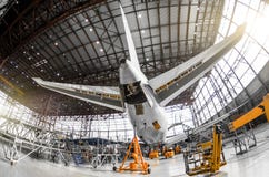 Large Passenger Aircraft On Service In An Aviation Hangar Rear View Of The Tail, On The Auxiliary Power Unitand Tail Altitude Cont Royalty Free Stock Image Large Passenger Aircraft On Service In An Aviation Hangar Rear View Of The Tail, On The Auxiliary Power Unitand Tail Altitude Cont Royalty Free Stock Image