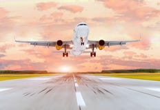 Large passenger plane take off from the runway before the light from the sunshine. stock image Large passenger plane take off from the runway before the light from the sunshine. stock image