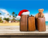 Retro large suitcases and santa hat on beach Stock Photos Retro large suitcases and santa hat on beach Stock Photos