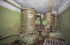 Large tanks with a supply of drinking water for autonomous existence in the underground shelter. An abandoned old shelter with a s stock images Large tanks with a supply of drinking water for autonomous existence in the underground shelter. An abandoned old shelter with a s stock images