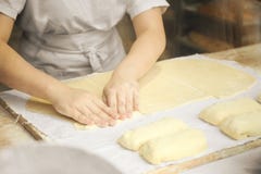 Las manos del cocinero amasan suavemente la pasta Poco panader?a de la familia foto de archivo libre de regalías Las manos del cocinero amasan suavemente la pasta Poco panader?a de la familia foto de archivo libre de regalías