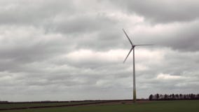 Las turbinas de viento hacen girar en el fondo de nubes oscuras metrajes Las turbinas de viento hacen girar en el fondo de nubes oscuras metrajes
